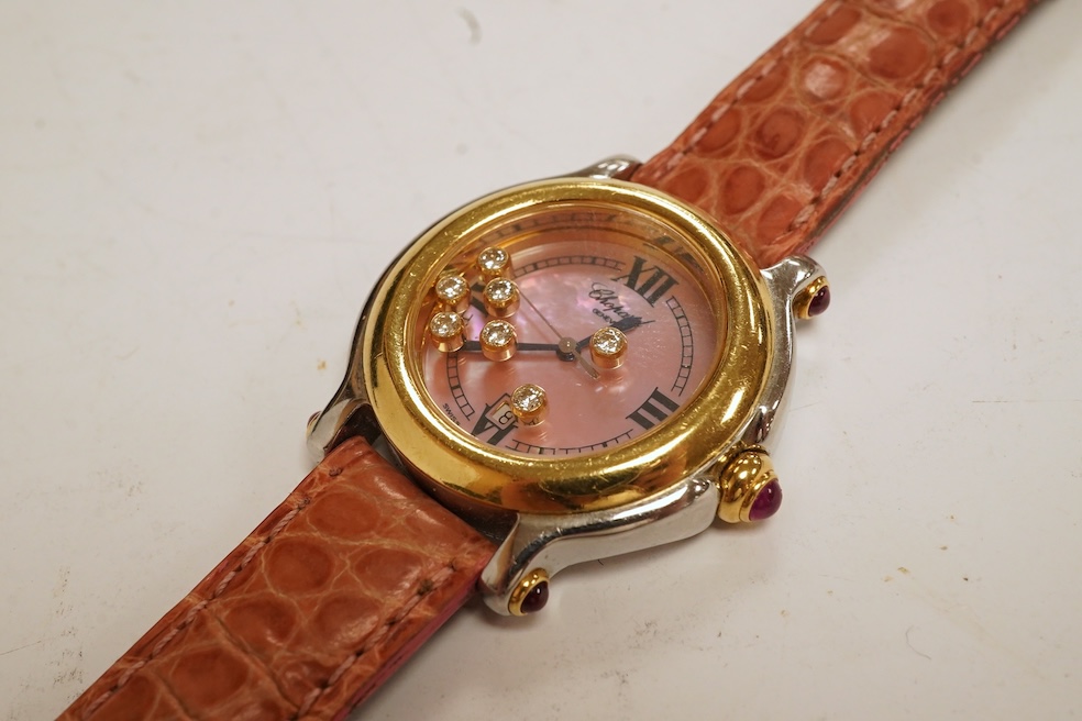 A lady's recent steel and gold Chopard 'Happy Sport' quartz wrist watch, the paua shell dial with seven 'floating' diamonds, on a leather strap wit gold plated Chopard clasp, with box, no papers. Condition - fair